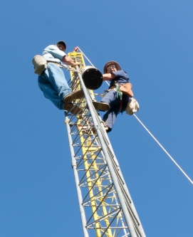 W0AIH and W0GJ in July 2009 installing the tower - it was a hot day!